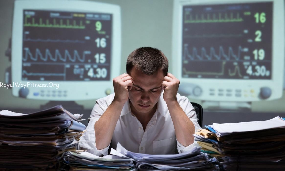 An exhausted worker experiencing burnout due to low health priority.