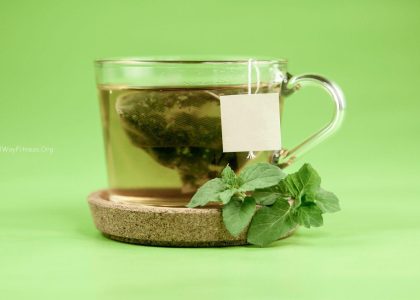 clear glass mug with green leaves