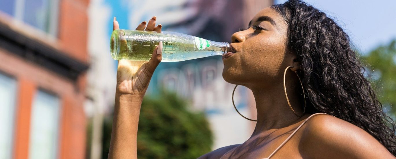 woman drinking water from bottle