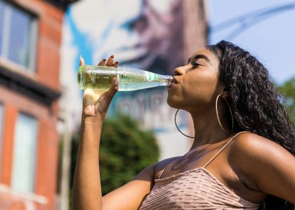 woman drinking water from bottle