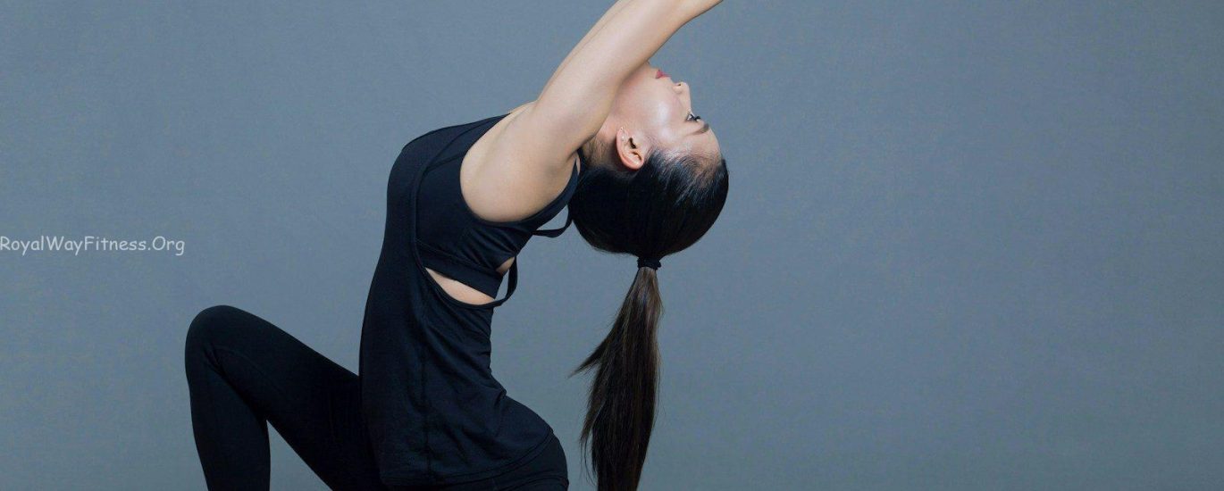 woman in black tank top and black pants doing yoga